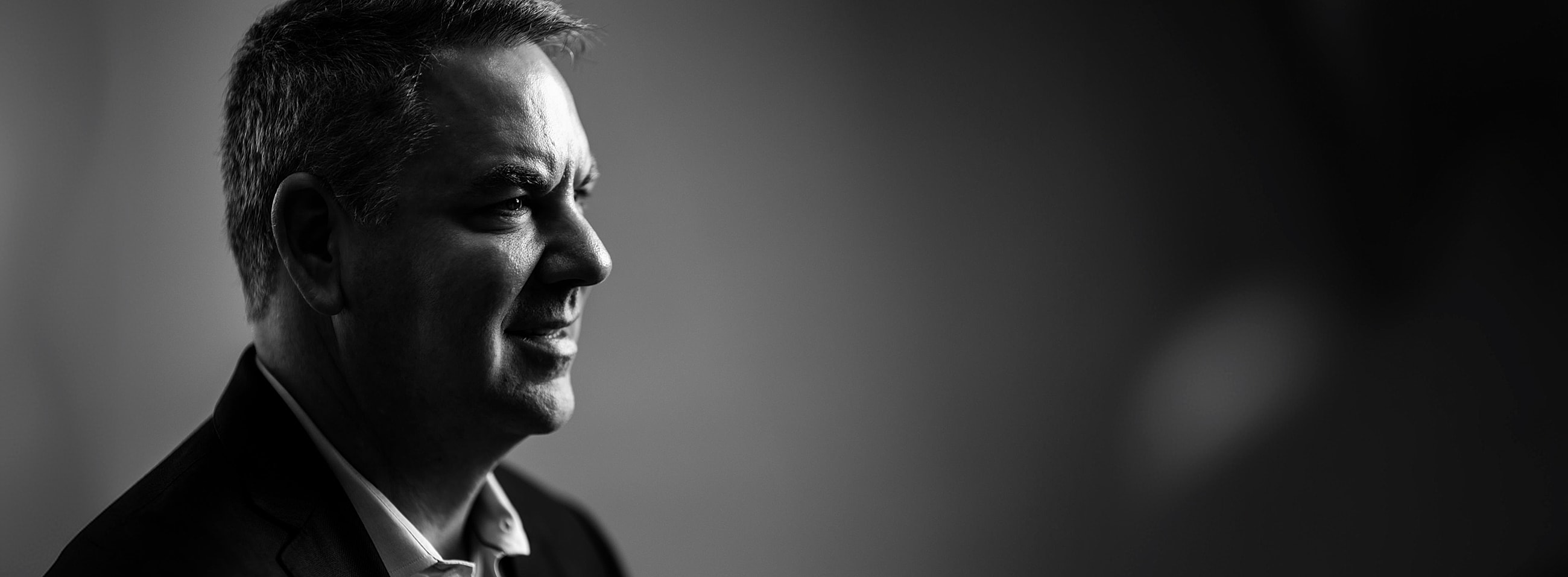 Profile portrait of a man in black and white.