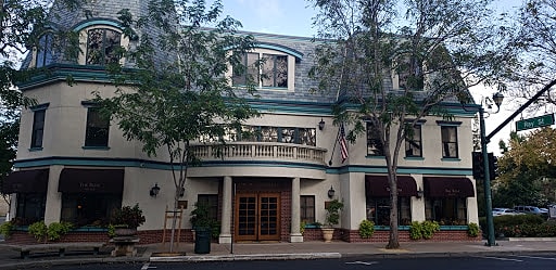 Historic building with decorative architecture and trees.