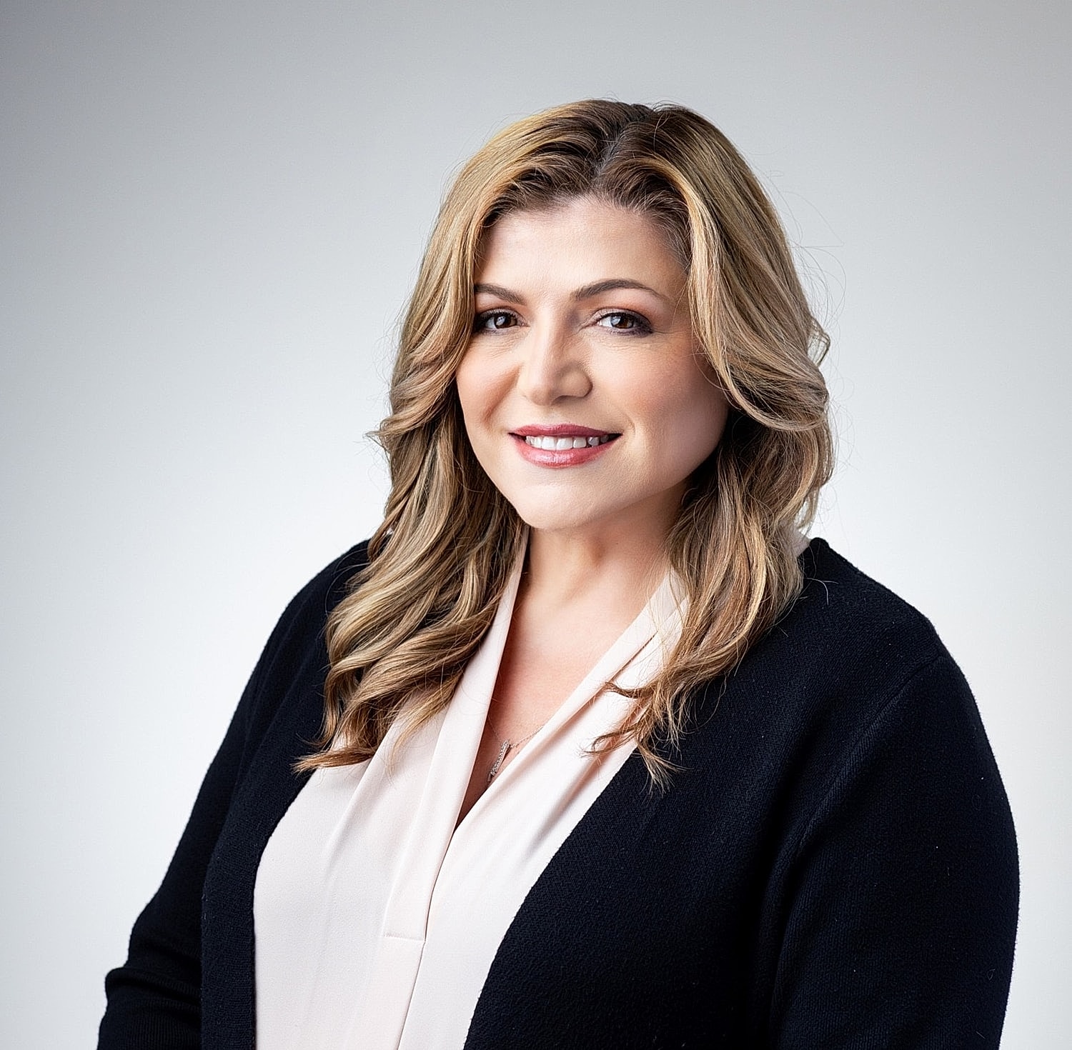 Professional portrait of a smiling woman.