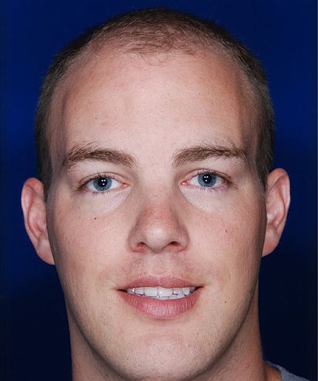 Young man with short hair and blue eyes.