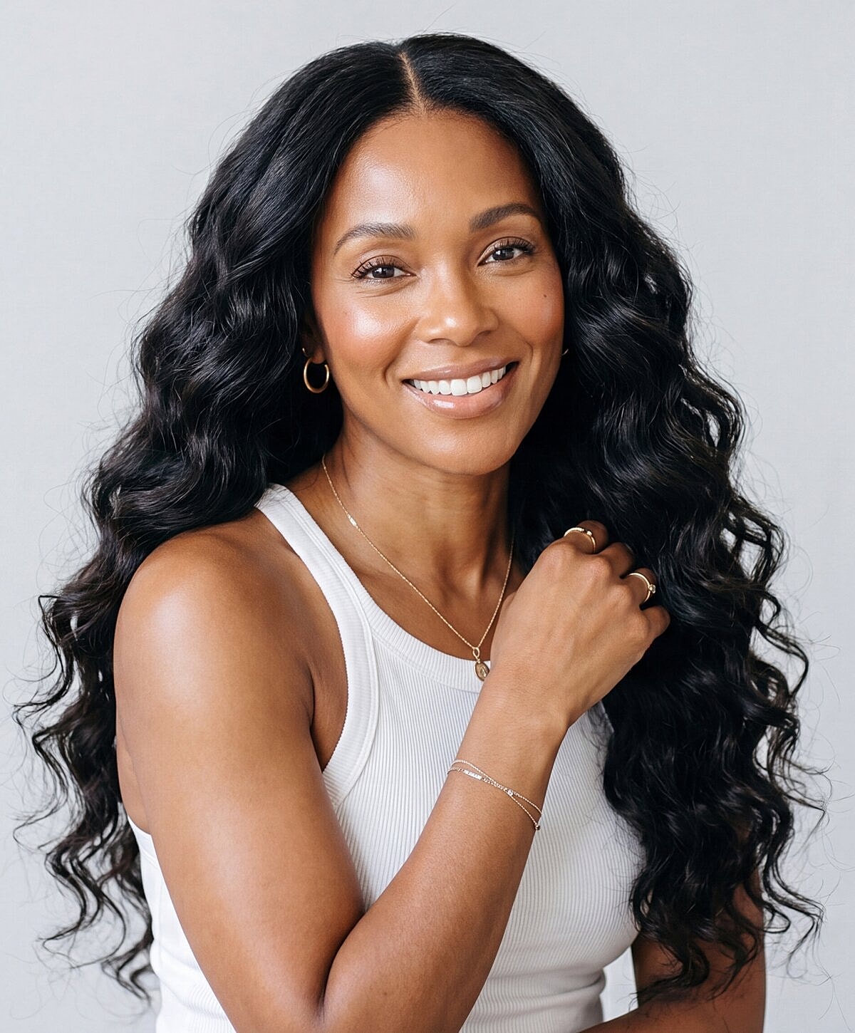 Smiling woman with long, wavy hair.