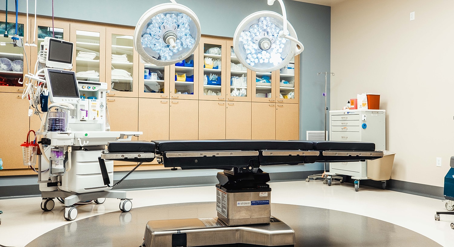 Surgical room with operating table and equipment.