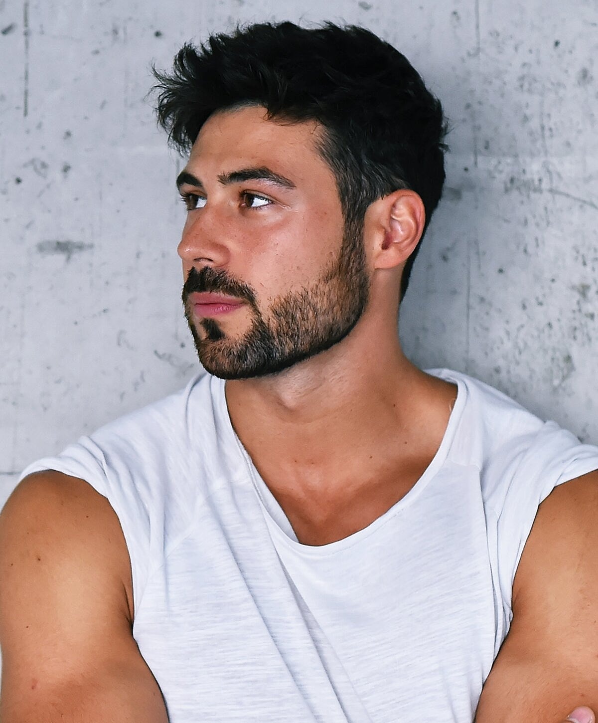 Man with beard in casual white shirt.