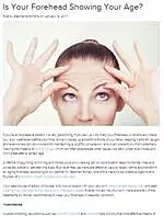 Woman examining her forehead for signs of aging.
