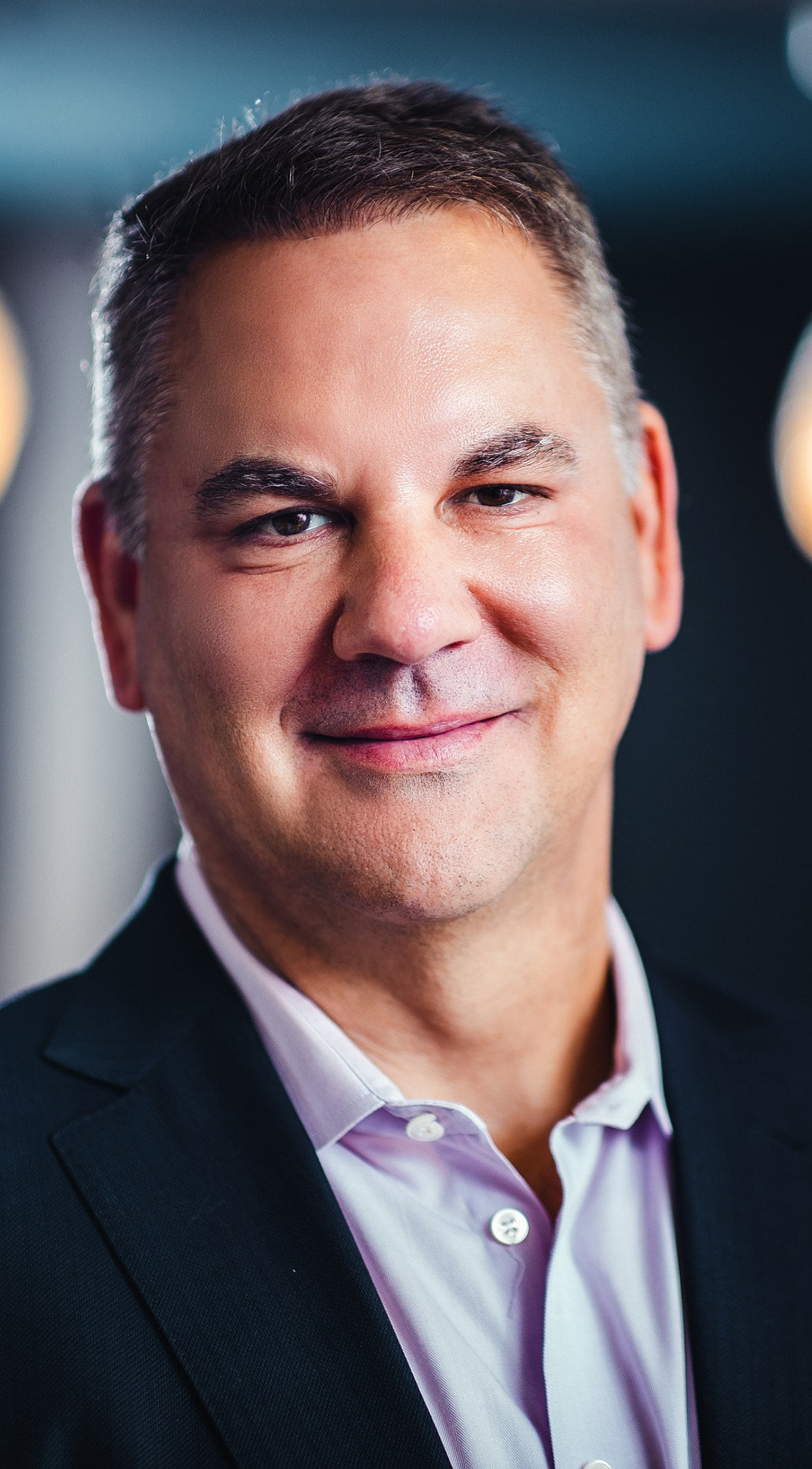 Professional man smiling in business attire.