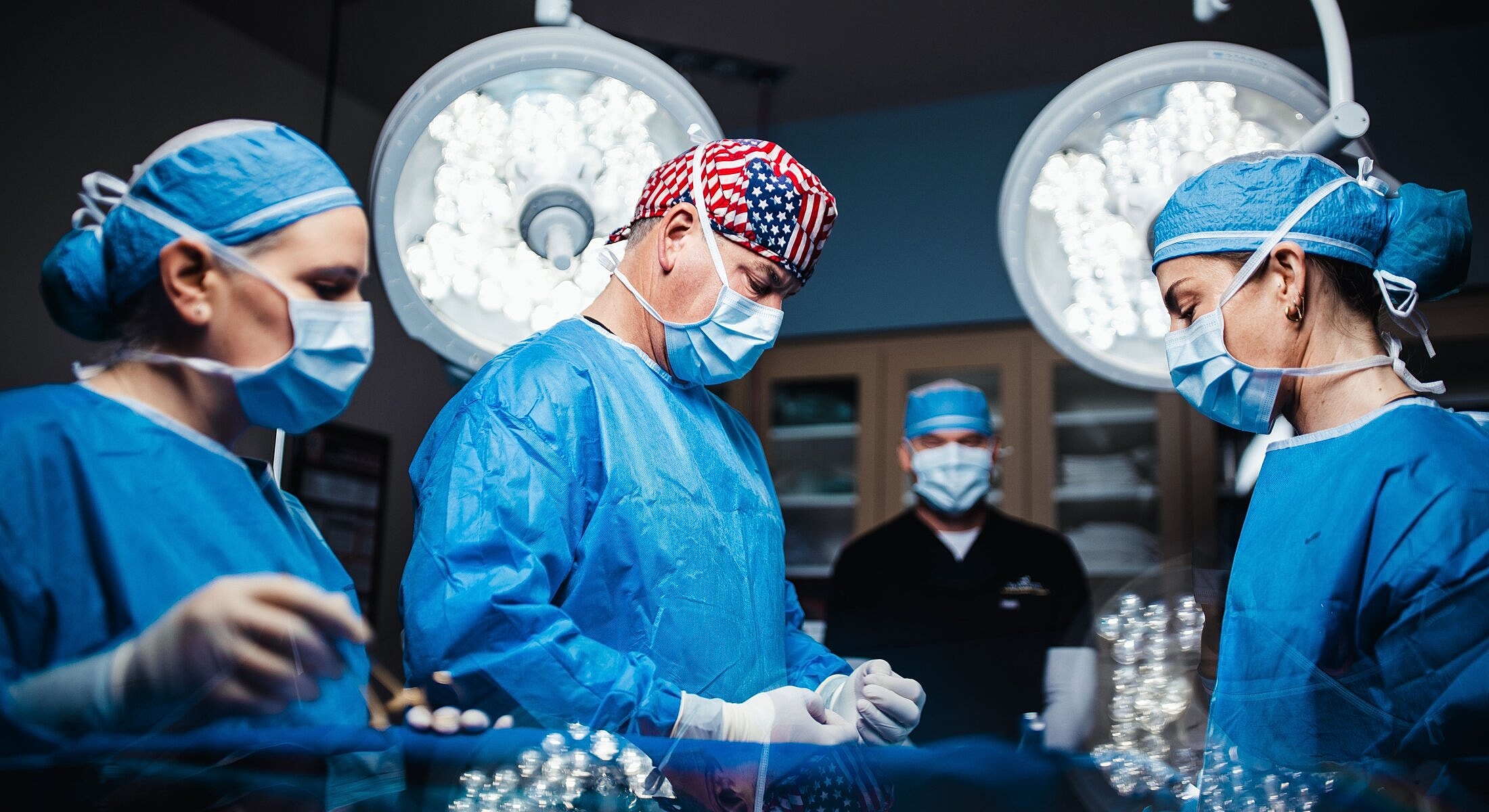 Surgeons performing a procedure in an operating room.