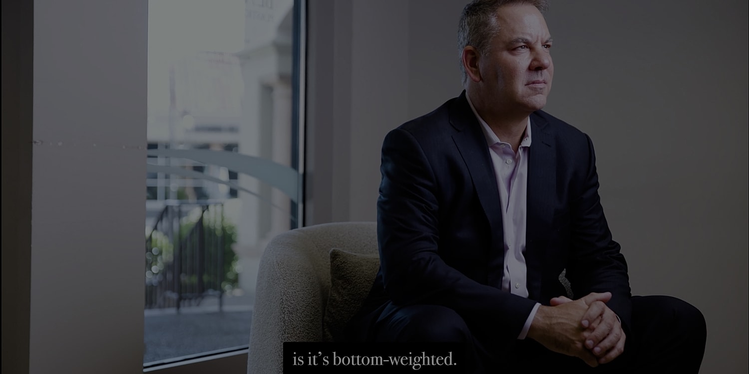 Man sitting in office, discussing bottom-weighted concept.
